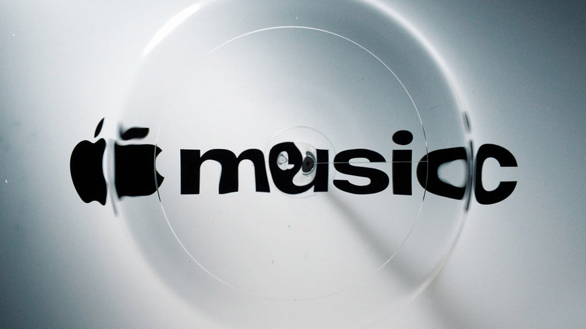 Apple Music logo rippling through a pool of oil during its physical creation process